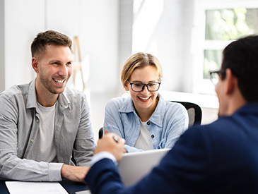 A mortgage adviser is speaking with his clients